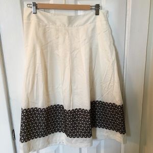 Pleated circle skirt with brown pattern detail.